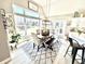 Bright dining room features a large window overlooking the lake, a stylish rug, and a long wood table with bench seating at 14035 Stone Key Way, Fishers, IN 46040