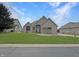 Charming single-story brick home with a well-manicured lawn and inviting front entrance at 14035 Stone Key Way, Fishers, IN 46040