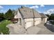 Spacious three-car garage attached to a well-kept brick home with manicured grounds at 14035 Stone Key Way, Fishers, IN 46040