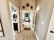 Hallway view highlighting the natural light and flow to the bathroom and living room at 14035 Stone Key Way, Fishers, IN 46040