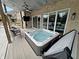 Backyard featuring an outdoor hot tub and covered patio with outdoor TV for relaxation and entertainment at 14035 Stone Key Way, Fishers, IN 46040