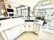 Bright kitchen island and open layout with a view into the dining and living area, perfect for entertaining guests at 14035 Stone Key Way, Fishers, IN 46040