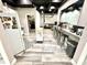 Basement kitchenette equipped with modern appliances, sleek countertops and a bar area at 14035 Stone Key Way, Fishers, IN 46040