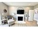 Cozy living room with a comfortable armchair, fireplace, and view into the bathroom through an open doorway at 14035 Stone Key Way, Fishers, IN 46040