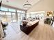 Open-concept living room with a fireplace, large windows, and seamless access to the outdoor patio at 14035 Stone Key Way, Fishers, IN 46040