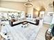 Open-concept living room with white accents, a fireplace, and seamless access to the kitchen at 14035 Stone Key Way, Fishers, IN 46040