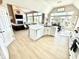 Open-concept living space with a fireplace, kitchen island, and dining area, creating a welcoming and functional layout at 14035 Stone Key Way, Fishers, IN 46040