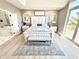 Large main bedroom features king bed, natural light, and a luxurious en-suite bathroom with marble tub at 14035 Stone Key Way, Fishers, IN 46040