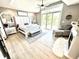 Spacious main bedroom with hardwood floors, a king bed, fireplace and a walkout to a deck area at 14035 Stone Key Way, Fishers, IN 46040