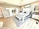 Bright bedroom with hardwood floors, king bed, and access to luxurious bathroom with walk in shower and tub at 14035 Stone Key Way, Fishers, IN 46040