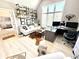 Well-lit home office with large window, decorative shelves, and comfortable seating area at 14035 Stone Key Way, Fishers, IN 46040