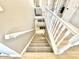 Carpeted staircase with painted white banister leading to the upper level of the house at 14035 Stone Key Way, Fishers, IN 46040