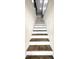 Elegant staircase with stained wood treads and white risers, adding a touch of sophistication to the home at 14035 Stone Key Way, Fishers, IN 46040