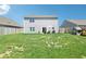 Wide shot of backyard featuring patio area, a large grassy space and perimeter fencing at 1452 Bigleaf Dr, Sheridan, IN 46069
