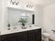 Bathroom featuring a double sink vanity, quartz counters and modern light fixtures at 1452 Bigleaf Dr, Sheridan, IN 46069