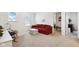 Cozy bedroom with a red couch, ottoman, and plenty of natural light at 1452 Bigleaf Dr, Sheridan, IN 46069