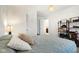 This bedroom offers natural light, comfortable bedding, and decorative shelves for personal touches at 1452 Bigleaf Dr, Sheridan, IN 46069