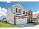 Side view of a modern two-story home featuring a gray vinyl exterior and attached garage at 1452 Bigleaf Dr, Sheridan, IN 46069