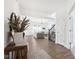 Inviting foyer with hardwood floors, light walls, staircase, and view into the living room at 1452 Bigleaf Dr, Sheridan, IN 46069