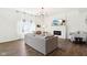 Bright living room with hardwood floors, fireplace, large windows, and a stylish chandelier at 1452 Bigleaf Dr, Sheridan, IN 46069