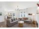 Inviting living room with hardwood floors, comfortable sofa, and plenty of natural light from large windows at 1452 Bigleaf Dr, Sheridan, IN 46069