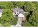 An aerial view of a charming two-story home, showcasing its mature trees, well-manicured lawn, and neighborhood at 14728 Adios Pass, Carmel, IN 46032