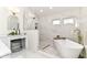 Luxurious bathroom featuring a freestanding tub, walk-in shower, and elegant vanity with modern fixtures at 14728 Adios Pass, Carmel, IN 46032
