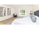 Sunlit bedroom with a comfortable seating area, large window, and stylish gray and white decor at 14728 Adios Pass, Carmel, IN 46032