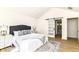 Modern bedroom features a plush bed, stylish rug, and sliding barn door leading to the bathroom at 14728 Adios Pass, Carmel, IN 46032