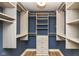 Spacious walk-in closet with custom shelving, drawers, and ample storage space, lit by modern lighting at 14728 Adios Pass, Carmel, IN 46032