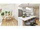 A modern kitchen with a quartz island, stainless appliances, stylish pendant lights and eat-in dining area at 14728 Adios Pass, Carmel, IN 46032