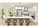 Contemporary kitchen with an island, breakfast bar seating, stainless appliances, and ample natural light at 14728 Adios Pass, Carmel, IN 46032