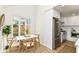 Bright kitchen featuring a dining nook, stainless steel appliances, and sleek white cabinets at 14728 Adios Pass, Carmel, IN 46032