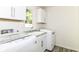 Well-lit laundry room equipped with modern appliances, ample storage, and a utility sink at 14728 Adios Pass, Carmel, IN 46032