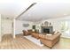 Spacious living room features modern vinyl floors, a stylish fireplace, and two matching Chesterfield sofas at 14728 Adios Pass, Carmel, IN 46032