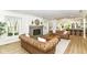 Spacious living room featuring modern vinyl floors, a stylish fireplace, and two matching Chesterfield sofas at 14728 Adios Pass, Carmel, IN 46032