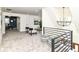 Cozy loft area with stylish seating, a modern chandelier, and view into an office space at 14728 Adios Pass, Carmel, IN 46032