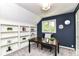 Office with built-in bookcase, natural light from window, and a modern desk at 14728 Adios Pass, Carmel, IN 46032