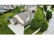 Aerial view showcasing a home with an attached three-car garage and mature trees at 1476 Anon Ct, Greenwood, IN 46143