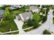 Aerial view of a home with a lush green lawn, a three-car garage, and mature trees at 1476 Anon Ct, Greenwood, IN 46143