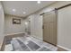 Finished basement with a sliding barn door and modern rug on wood-look flooring at 1476 Anon Ct, Greenwood, IN 46143