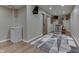 Finished basement featuring a bar area with wood-look flooring and a modern sliding barn door at 1476 Anon Ct, Greenwood, IN 46143
