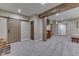 Finished basement with a rustic wooden beam, a sliding barn door, and neutral carpeting, creating a warm and inviting atmosphere at 1476 Anon Ct, Greenwood, IN 46143