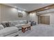 Basement with a comfortable sectional sofa, a rustic wooden coffee table, and a sliding barn door, perfect for relaxation at 1476 Anon Ct, Greenwood, IN 46143