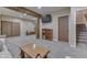 Finished basement featuring a rustic wooden beam, shelving, and sliding barn doors, offering a cozy and functional living space at 1476 Anon Ct, Greenwood, IN 46143