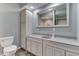 Modern bathroom with a white vanity, gray countertop, and a large mirror, offering a clean and stylish design at 1476 Anon Ct, Greenwood, IN 46143