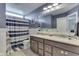 Nautical-themed bathroom featuring a double vanity, striped shower curtain, and a well-lit mirror for a bright, refreshing space at 1476 Anon Ct, Greenwood, IN 46143