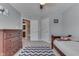 Bedroom with wood frame bed, gray walls, carpet flooring, blue and white chevron patterned rug, and doors to other rooms at 1476 Anon Ct, Greenwood, IN 46143