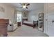 Cozy bedroom with a ceiling fan, a wooden bed frame, and neutral carpet flooring for a comfortable and inviting space at 1476 Anon Ct, Greenwood, IN 46143