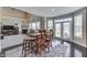 Open-concept dining area featuring hardwood floors, table, and views of the backyard at 1476 Anon Ct, Greenwood, IN 46143
